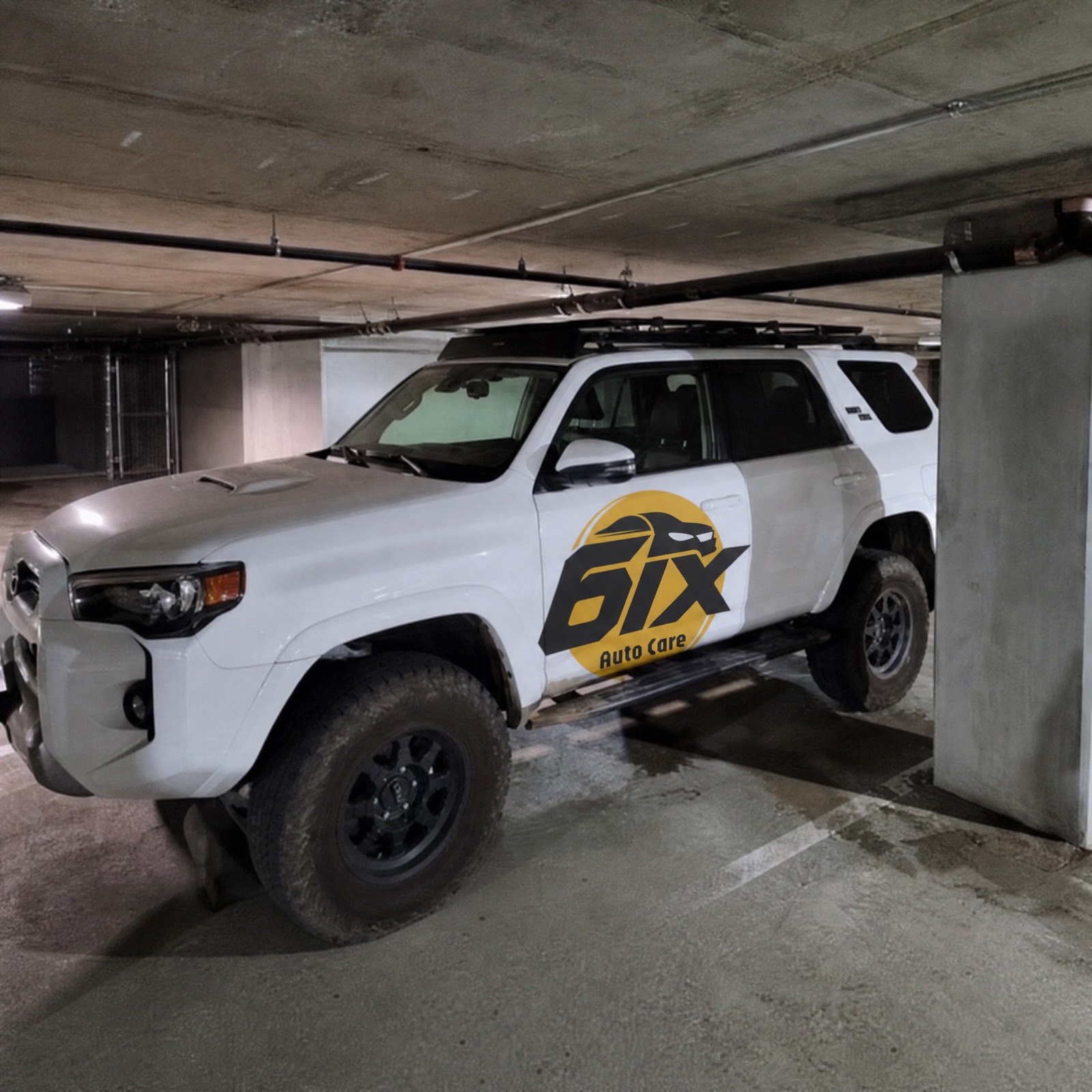 6ix Auto Care branded 4Runner in underground parking garage